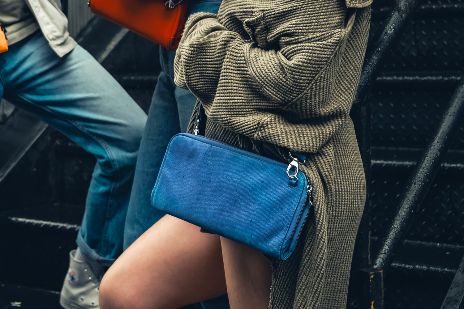 House of Alimena denim blue clutch lifestyle shot - luxury leather handbag with organized compartments